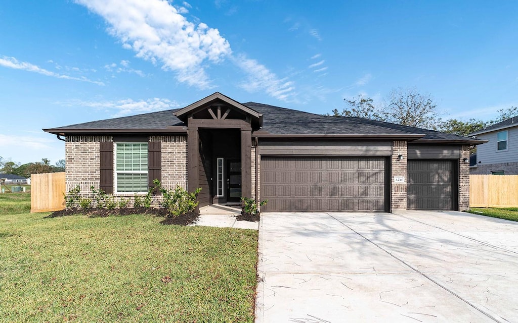 view of front of house featuring a garage and a front lawn