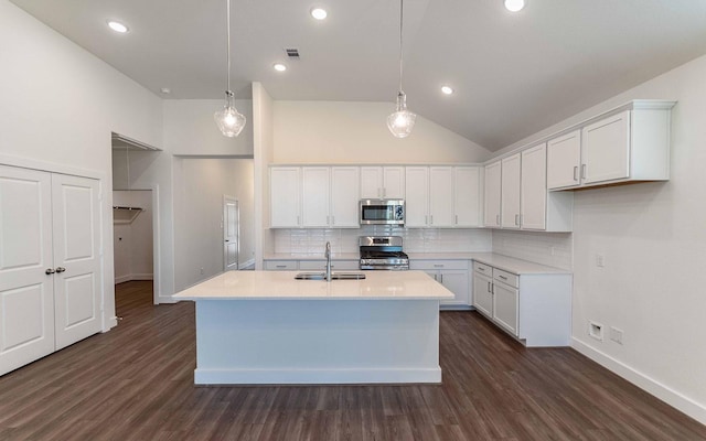 kitchen featuring sink, white cabinetry, stainless steel appliances, and hanging light fixtures