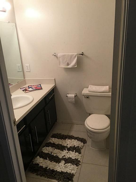 bathroom with tile patterned floors, vanity, and toilet