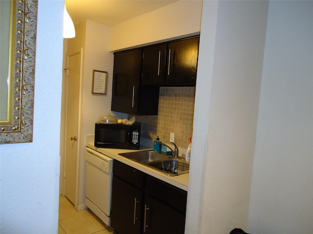 kitchen featuring sink, white dishwasher, decorative light fixtures, decorative backsplash, and light tile patterned flooring