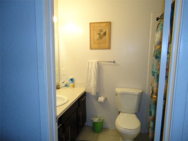 bathroom with tile patterned floors, vanity, and toilet