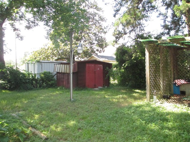 606 E Humble St, Baytown, TX 77520 - view of yard with an outbuilding and a storage shed