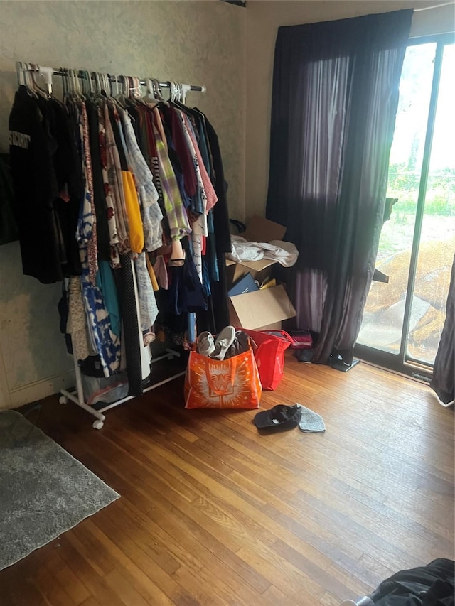 606 E Humble St, Baytown, TX 77520 - bedroom featuring wood finished floors and access to outside
