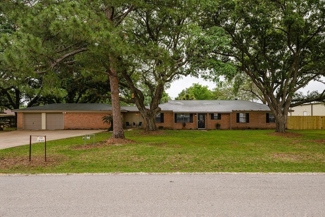 ranch-style home featuring a garage and a front lawn