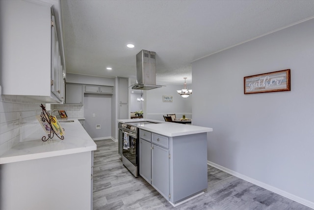 kitchen with decorative light fixtures, gray cabinets, island exhaust hood, light wood-type flooring, and stainless steel range with electric cooktop