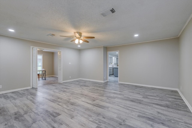 empty room featuring a textured ceiling, ceiling fan, crown molding, and light hardwood / wood-style flooring