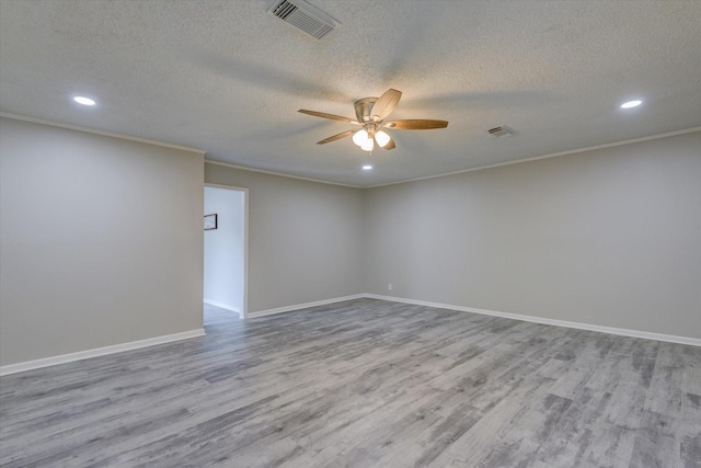 spare room featuring ceiling fan, crown molding, a textured ceiling, and light hardwood / wood-style flooring