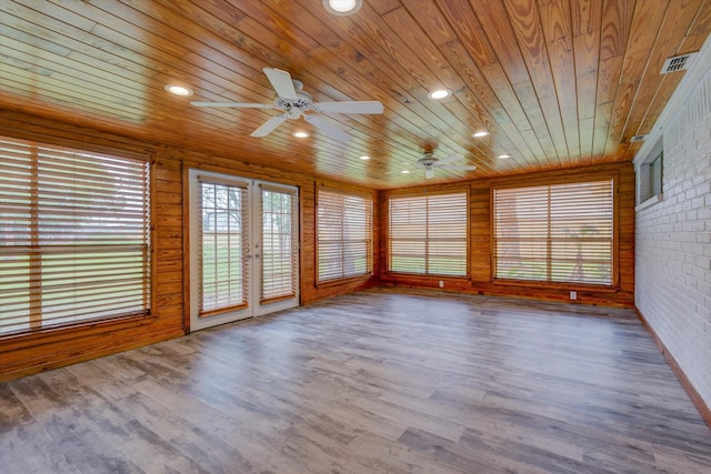 unfurnished sunroom featuring ceiling fan, wood ceiling, and french doors