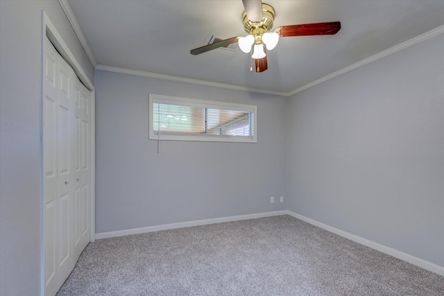 unfurnished bedroom featuring ceiling fan, ornamental molding, a closet, and light colored carpet