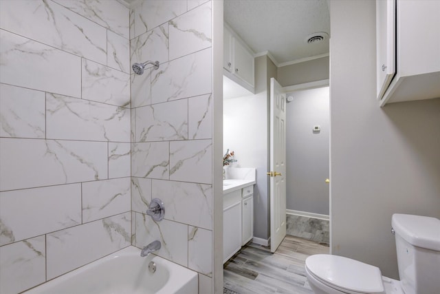 full bathroom with toilet, tiled shower / bath combo, hardwood / wood-style flooring, crown molding, and vanity