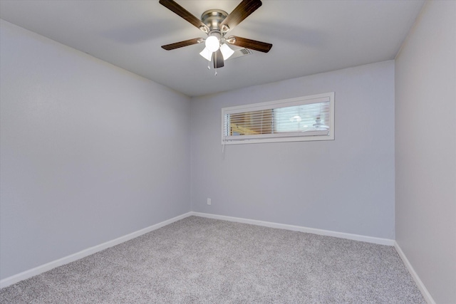 carpeted spare room featuring ceiling fan