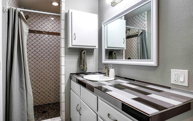 bathroom with vanity and walk in shower