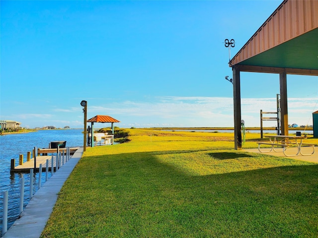 view of yard featuring a boat dock and a water view