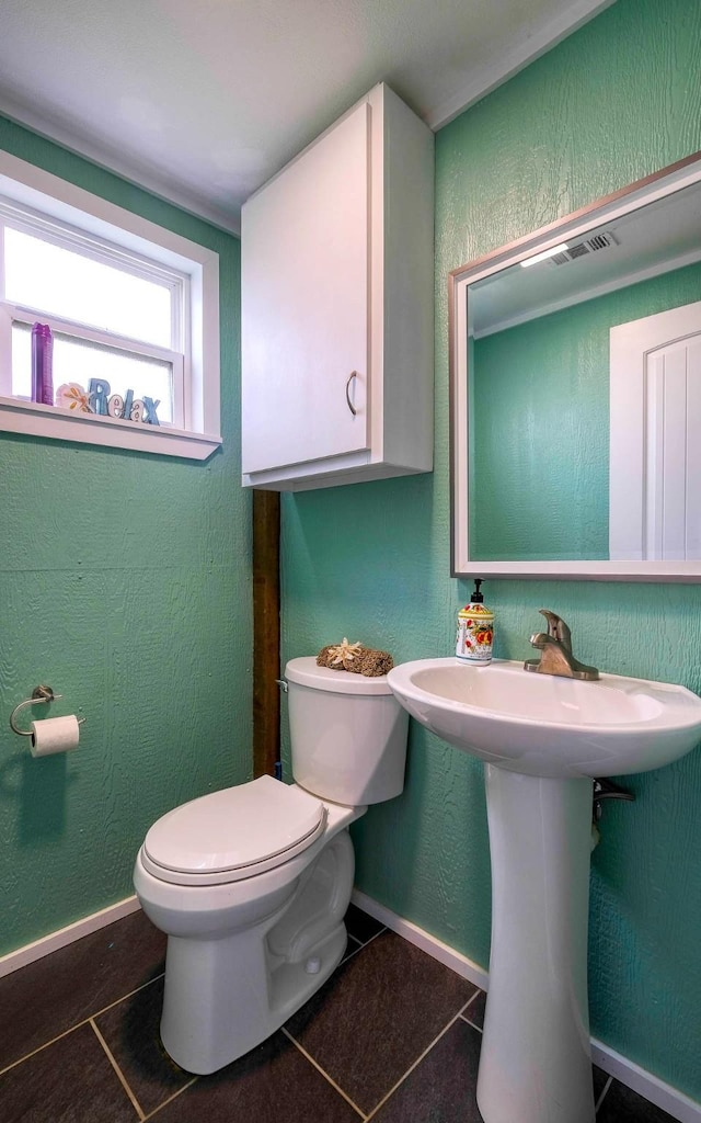 bathroom featuring sink, tile patterned floors, and toilet