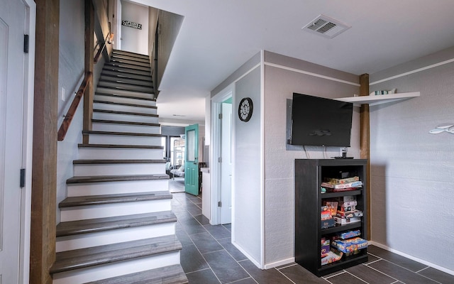 staircase with tile patterned floors