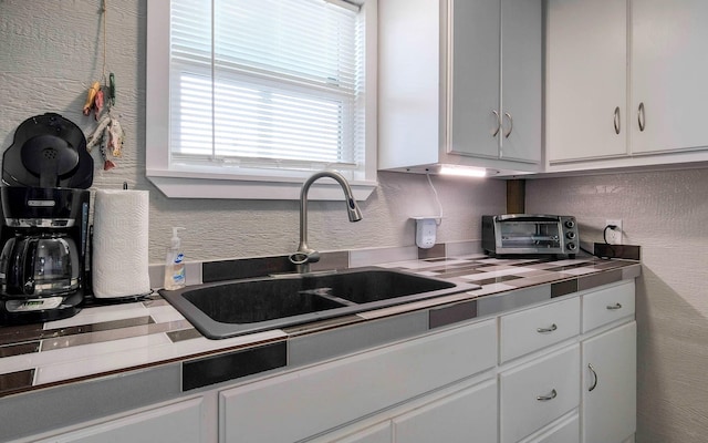 kitchen with sink and white cabinets