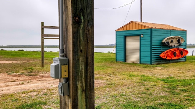 view of outdoor structure featuring a yard and a water view