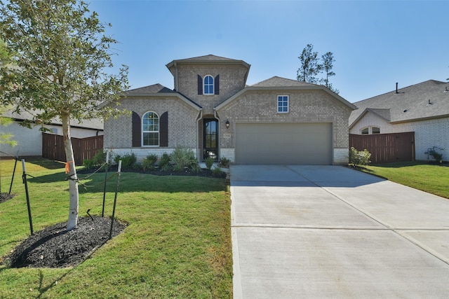 view of front of house with a garage and a front lawn