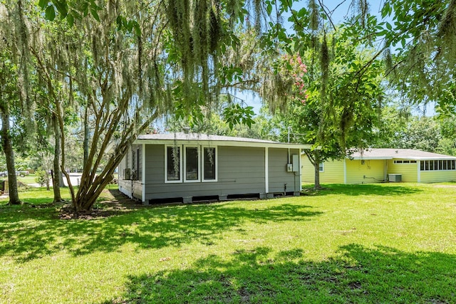 rear view of property with a yard