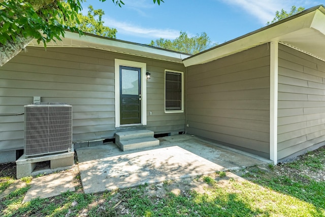 exterior space with central AC unit and a patio area