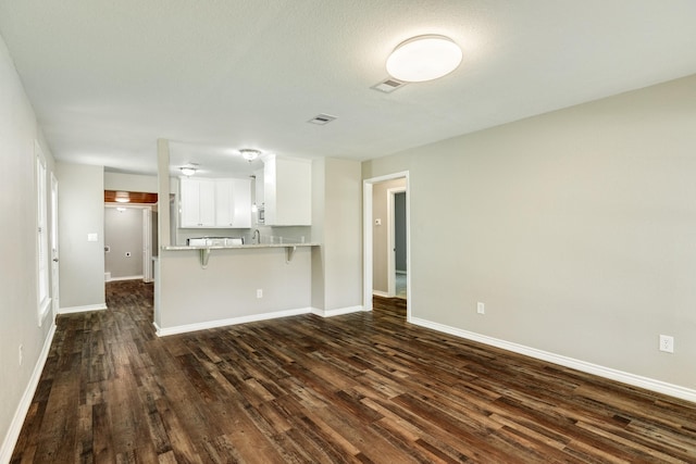 unfurnished living room featuring dark wood-type flooring