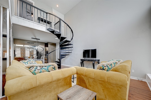 living room featuring high vaulted ceiling and wood-type flooring