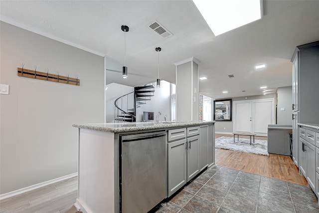 kitchen featuring dishwasher, decorative light fixtures, wood-type flooring, a kitchen island, and ornamental molding