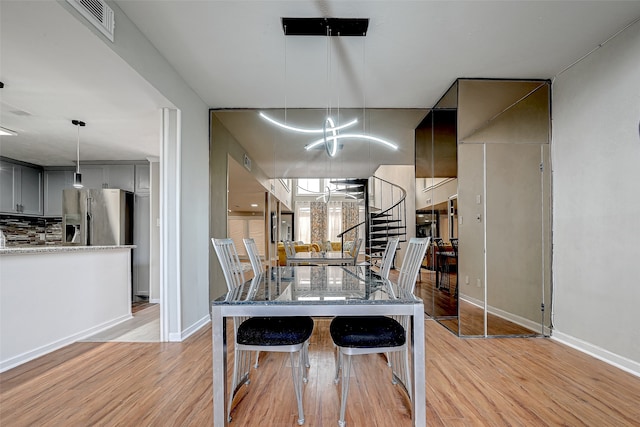 dining room featuring a chandelier and light wood-type flooring