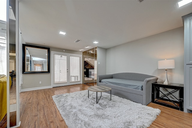 living room with hardwood / wood-style flooring and french doors