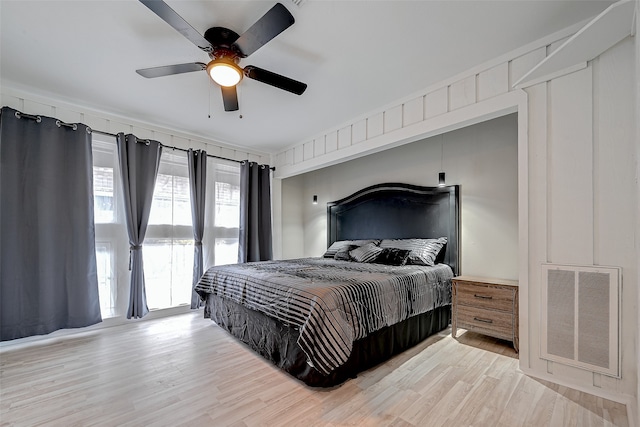 bedroom featuring ceiling fan, light wood-type flooring, and access to exterior