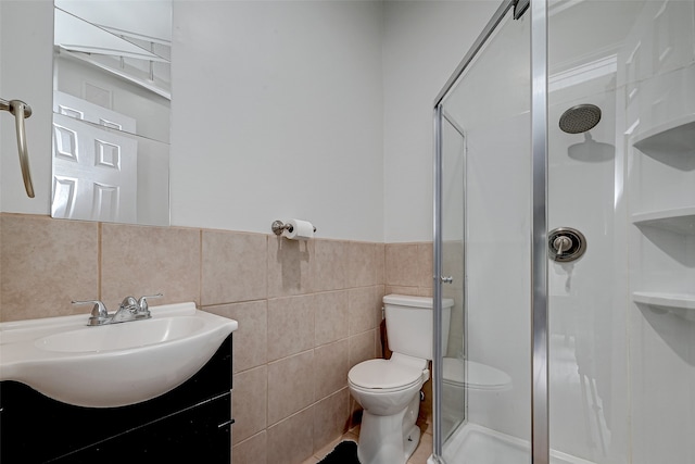 bathroom featuring a shower with shower door, vanity, toilet, and tile floors