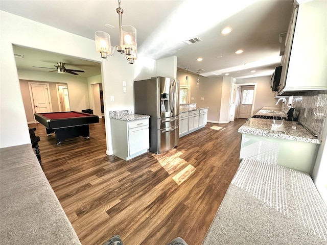 kitchen featuring pool table, dark hardwood / wood-style floors, stainless steel fridge, tasteful backsplash, and white cabinets