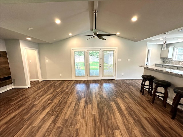 living room featuring ceiling fan, vaulted ceiling, and dark hardwood / wood-style flooring