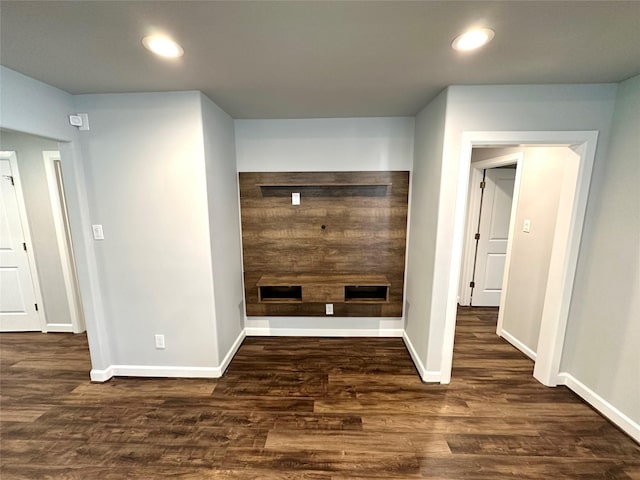 unfurnished living room featuring dark hardwood / wood-style floors