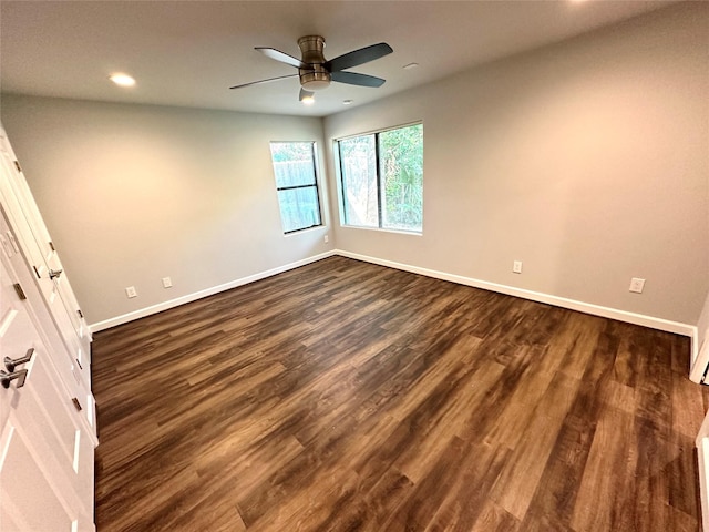 spare room with ceiling fan and dark hardwood / wood-style flooring