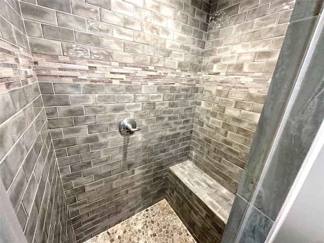 bathroom with a tile shower