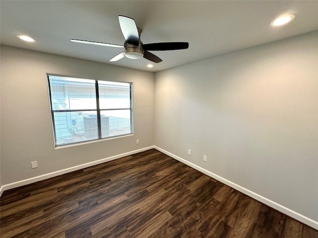 spare room featuring ceiling fan and dark wood-type flooring