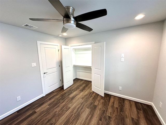 unfurnished bedroom with a closet, ceiling fan, and dark hardwood / wood-style floors