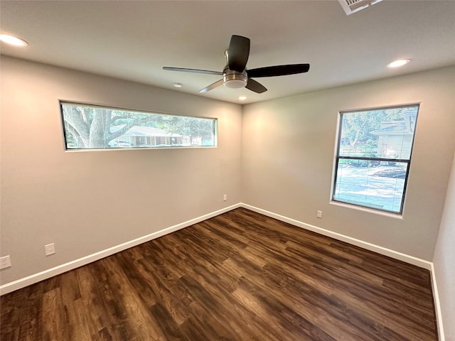 spare room featuring ceiling fan and dark wood-type flooring