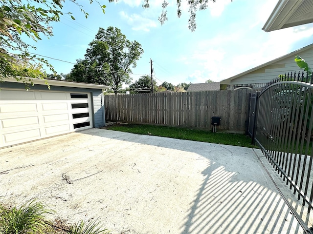 exterior space with a garage and an outbuilding