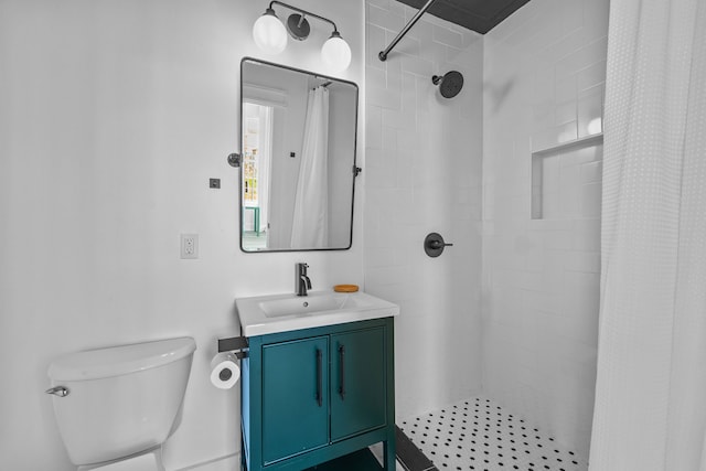 bathroom with walk in shower, vanity, and toilet