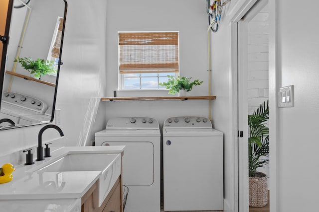 clothes washing area featuring sink and independent washer and dryer