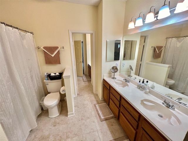 bathroom featuring tile patterned flooring, vanity, and toilet