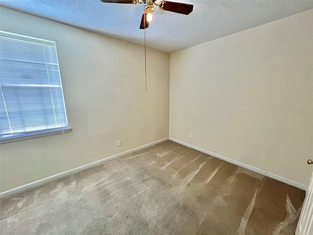 carpeted spare room with ceiling fan and a textured ceiling