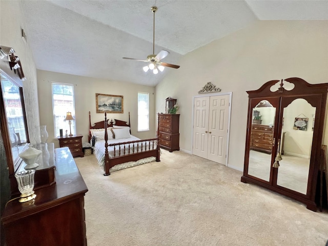 bedroom featuring a textured ceiling, light colored carpet, ceiling fan, and lofted ceiling