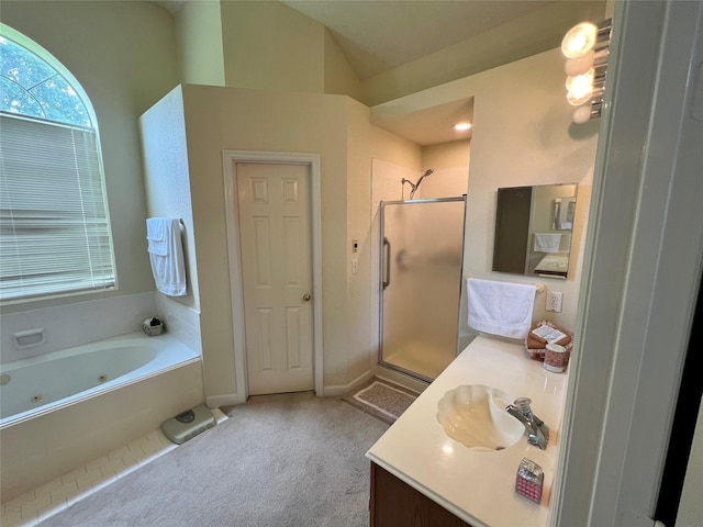 bathroom featuring vanity and independent shower and bath