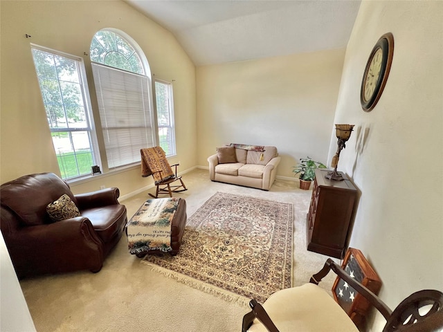 carpeted living room featuring lofted ceiling