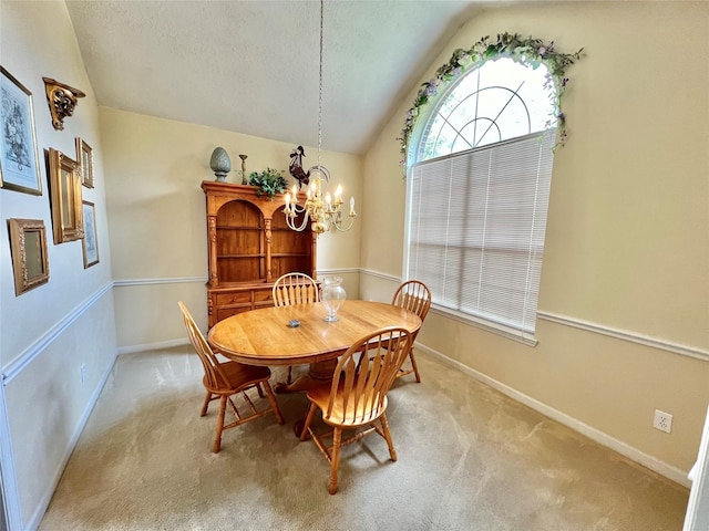 dining room featuring light carpet, a textured ceiling, an inviting chandelier, and vaulted ceiling