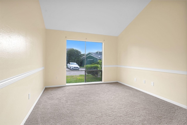 empty room featuring carpet floors and lofted ceiling