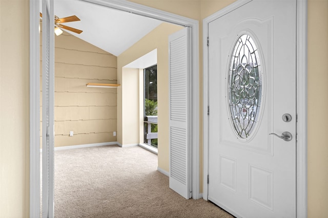 carpeted entryway featuring ceiling fan and lofted ceiling